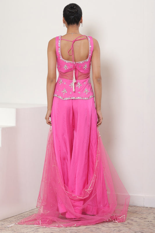 Woman wearing a pink traditional outfit with a white background; Pink satin organza sharara, embroidered festive outfit, elegant occasional wear, designer ethnic attire, premium traditional set, Sunanta Madaan, near me, Mumbai, Delhi, Hyderabad, Bangalore, Pune