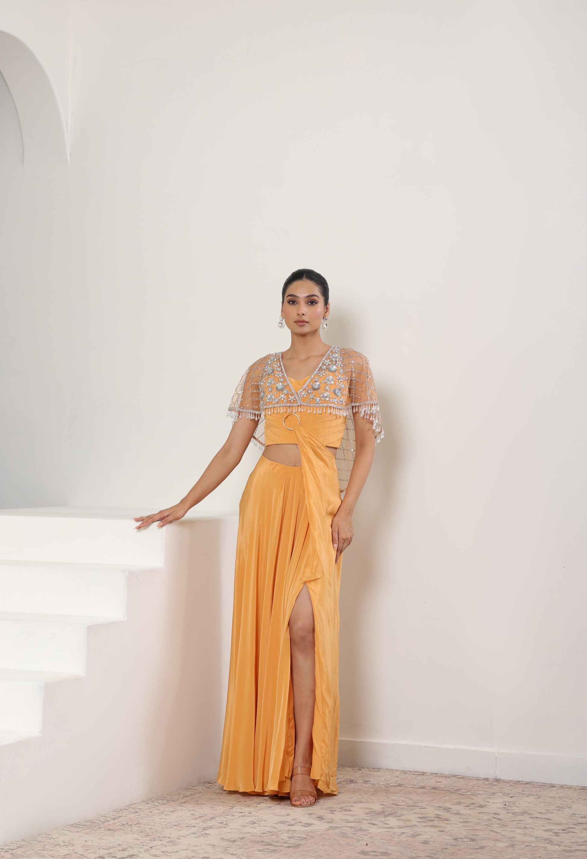 Woman in a yellow evening gown with a white background