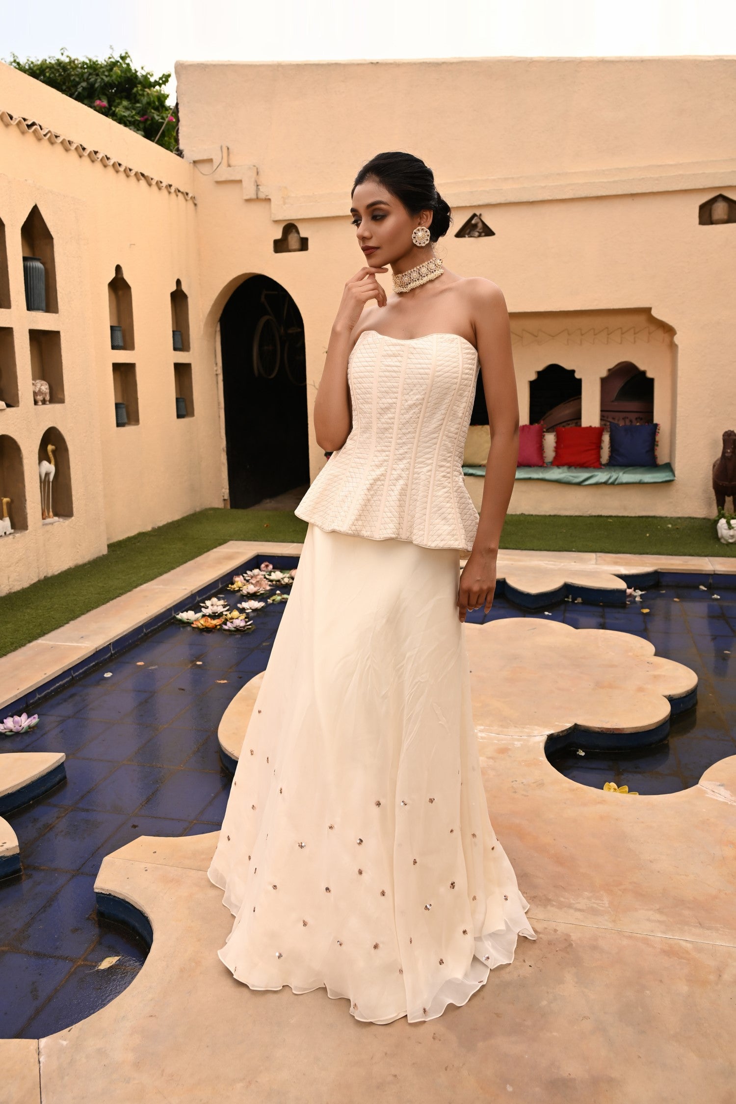 Charming ivory sharara, designed for an elegant and sophisticated look. This stunning party wear sharara set combines a stylish peplum top with a flowing sharara, making it the perfect choice for Indian bridal events or festive occasions. The peplum top sharara set offers a modern twist on traditional style, while the crop top sharara set is ideal for a haldi ceremony or any celebratory gathering. Sunanta Madaan