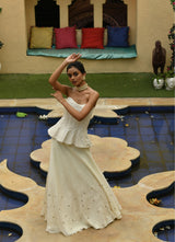 Elegant ivory designer organza lehenga by Sunantamadaan featuring a stylish corset, perfect for an Indian wedding or wedding reception. This exquisite lehenga set for women is adorned with sequins, making it a stunning choice for a marriage lehenga or party wear.