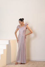 Woman in a long, light-colored dress standing against a plain background; Sunanta Madaan – Pink Metallic Lycra Crepe Embroidered Gown, Elegant Designer Wear, Evening Party Dress, Boho Indo-Western Dress, Indo-Western Fusion Wear, Women’s Formal Gown, Indo-Western Outfit for Reception, Party Outfit, Indo-Western Draped Dress, Mumbai, Jaipur, Bangalore, Ahmedabad, Pune, near me