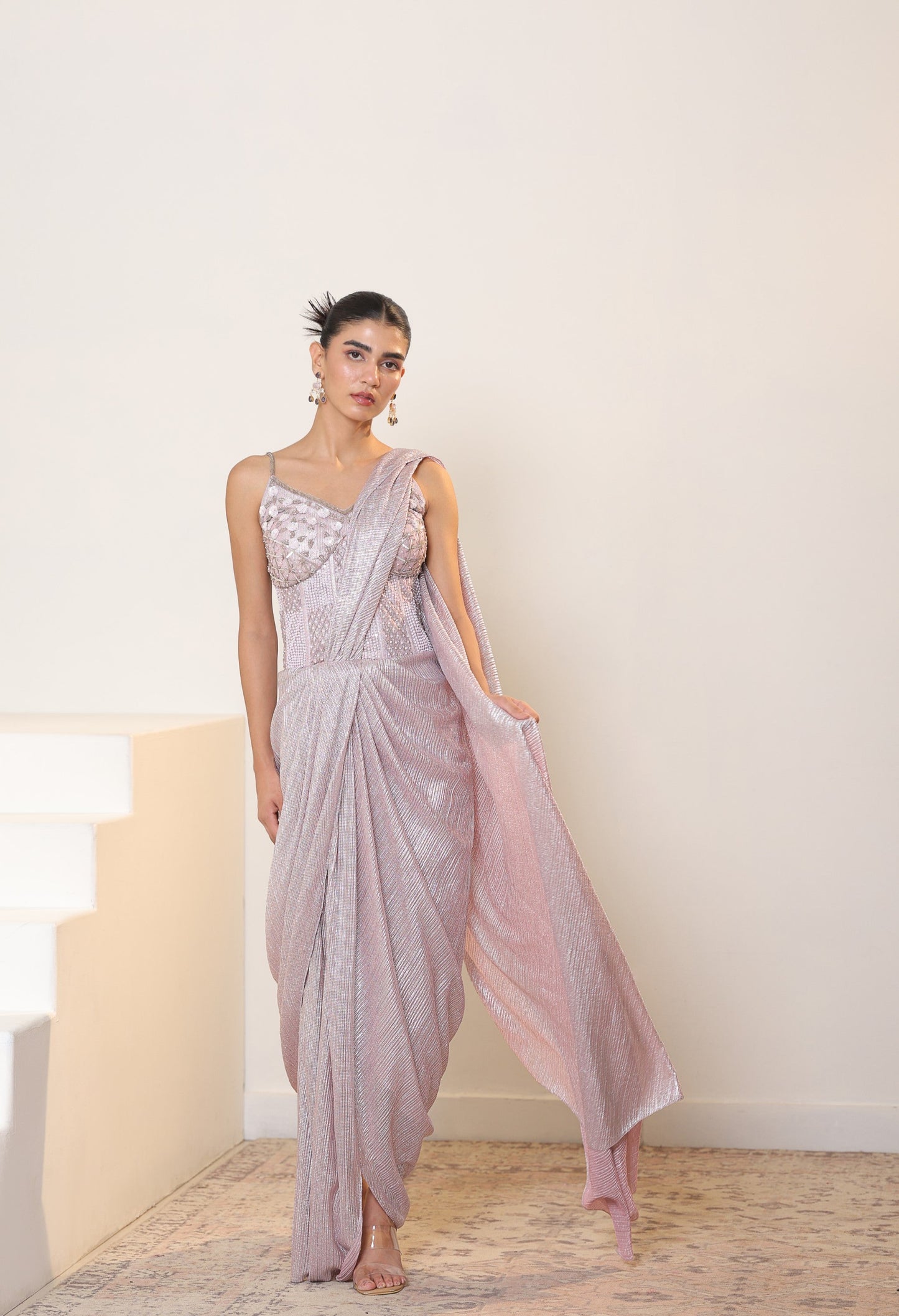 Woman wearing a light purple saree with a white background; Sunanta Madaan – Pink Metallic Lycra Crepe Saree, Premium Reception Wear, Elegant Party Outfit, Boho Indo-Western Dress, Indo-Western Fusion Wear, Women’s Formal Evening Dress, Indo-Western Outfit for Reception, Party Outfit, Indo-Western Draped & Embroidered Saree, Delhi, Jaipur, Hyderabad, Ahmedabad, Bangalore, near me
