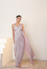 Woman wearing a light purple saree with a white background; Sunanta Madaan – Pink Metallic Lycra Crepe Saree, Premium Reception Wear, Elegant Party Outfit, Boho Indo-Western Dress, Indo-Western Fusion Wear, Women’s Formal Evening Dress, Indo-Western Outfit for Reception, Party Outfit, Indo-Western Draped & Embroidered Saree, Delhi, Jaipur, Hyderabad, Ahmedabad, Bangalore, near me