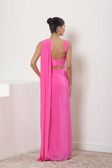 Woman wearing a bright pink saree with a matching blouse against a white background; Pink crepe saree, embroidered cocktail saree, premium party wear saree, designer festive outfit, elegant evening saree, Sunanta Madaan