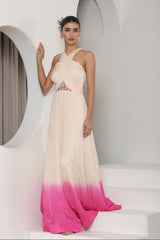 Woman wearing a long, gradient dress with a white top and pink bottom in a minimalistic setting. Ivory pink jumpsuit, satin organza outfit, embroidered festive wear, elegant designer jumpsuit, premium ethnic attire, Sunanta Madaan, near me, Mumbai, Delhi, Hyderabad, Bangalore, Pune