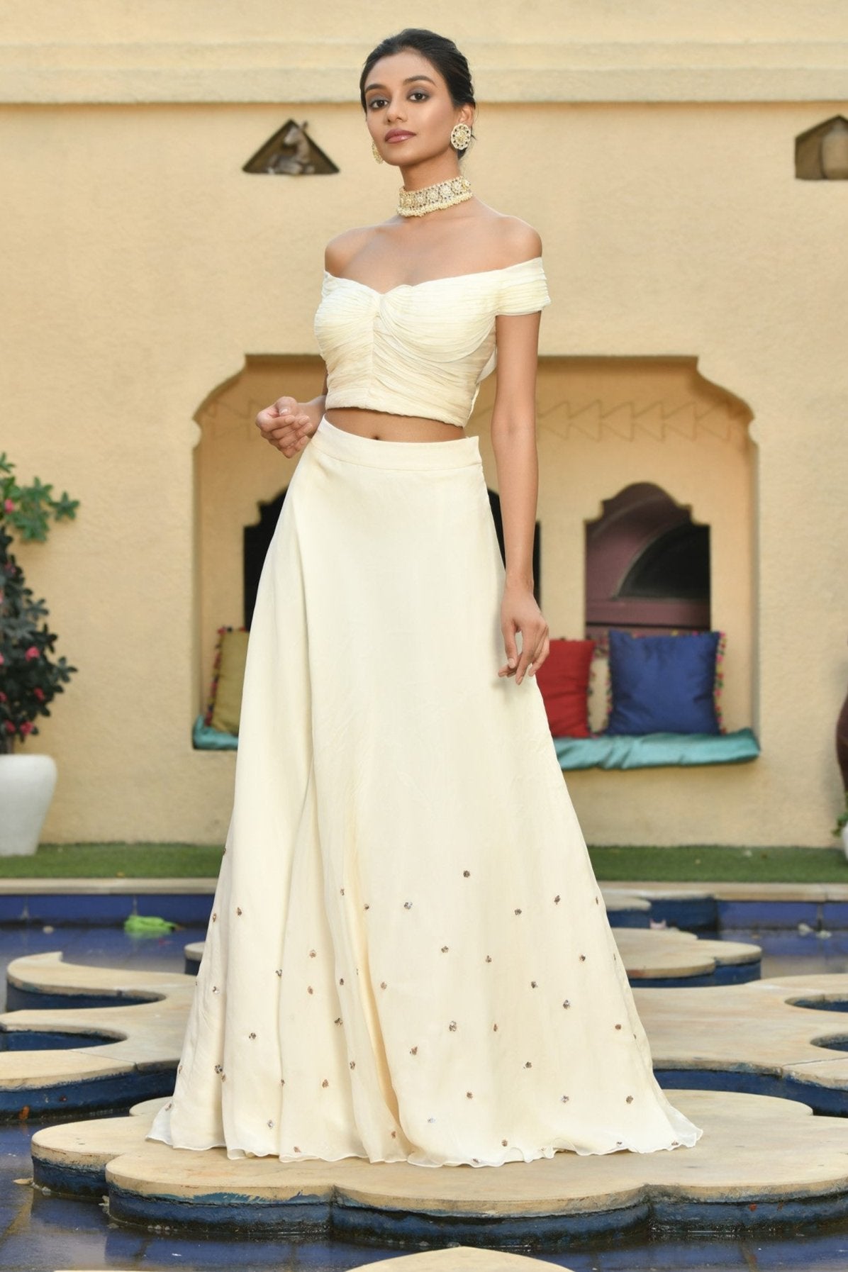 Ivory Indo-Western lehenga set with sequins work and blouse, perfect for party wear, festive occasions, or a reception. This luxury bridal lehenga from the bridal collection is available online, offering a stunning, designer look for your special day. Sunanta Madaan 