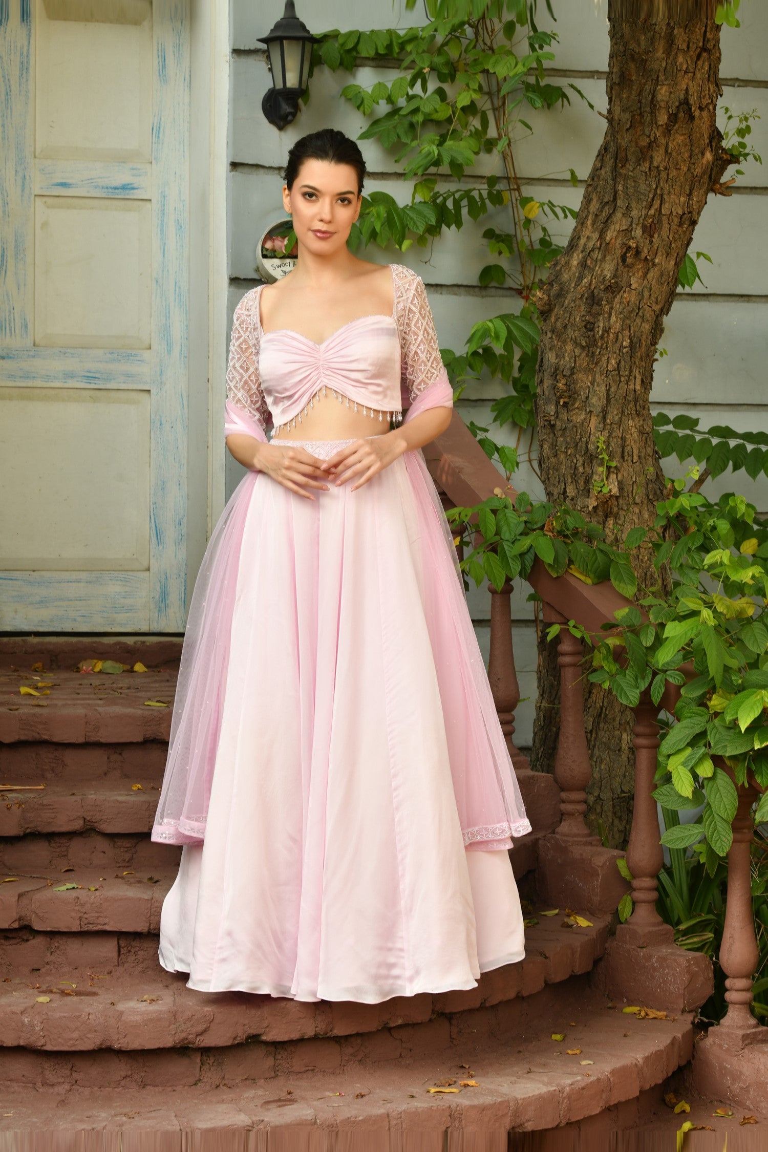 Intricately embroidered ghagra choli in an Indo Western style, blending traditional lehengas with a contemporary fashion industry look. -Elegant pink Indo-Western lehenga choli with a stylish lehenga blouse design and draped lehenga dupatta,