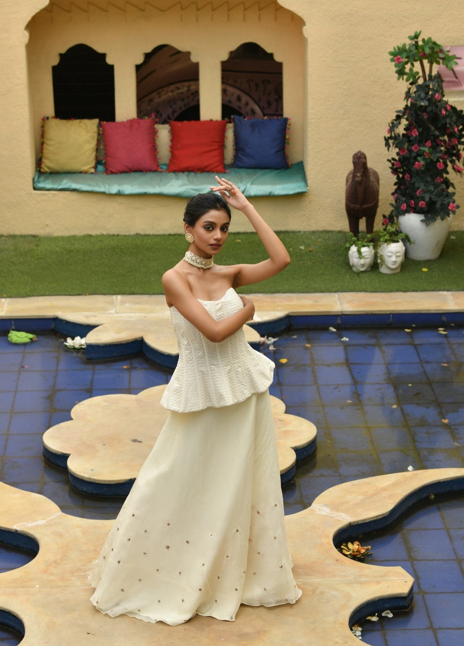 Charming ivory indo-western lehenga with a corset, designed by Sunantamadaan. This party wear crop top lehenga combines modern style with traditional elegance, making it perfect for a wedding. The lehenga dress features a chic choli lehenga design, ideal for brides looking for a stylish bridal dress lehenga with an indo-western lehenga flair.