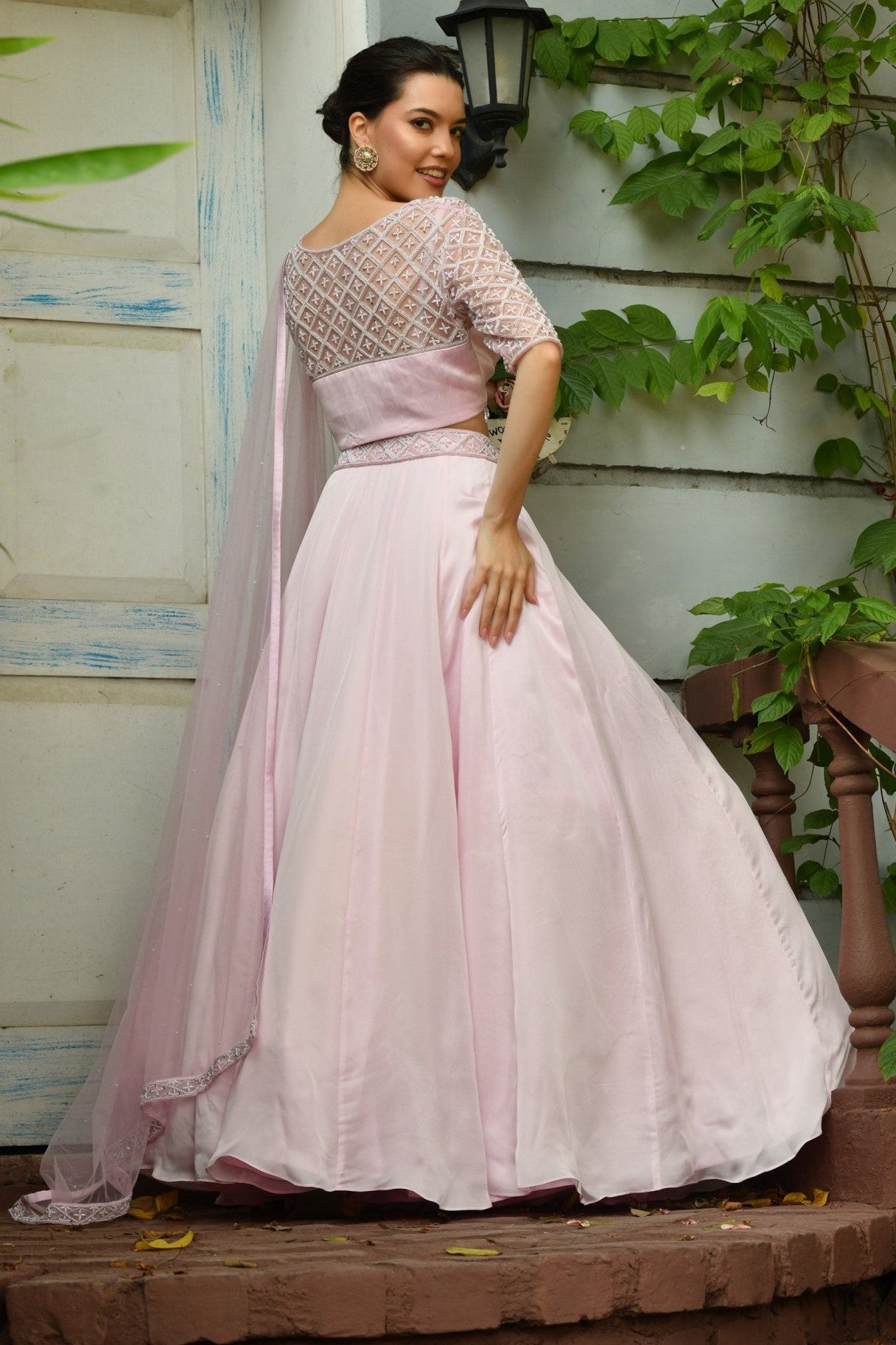 Indo Western Lehenga Choli – A fusion of traditional Indian lehenga and western lehengas for women, ideal for weddings and special occasions.A designer pink lehenga with an Indo-Western blouse, crafted for modern elegance. The lehenga blouse design features intricate hand embroidery with a stylish back and front pattern. Paired with a gracefully draped lehenga dupatta, this Indo-Western outfit for women is perfect for brides, bridesmaids, and wedding receptions. A blend of tradition and contemporary style, 