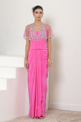 Woman wearing a pink dress with an embroidered top against a white background; Pink crepe skirt set, embroidered cape outfit, handcrafted engagement wear, elegant festive ensemble, designer ethnic attire, Sunanta Madaan