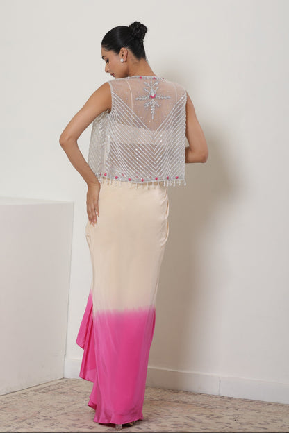 Woman wearing a sleeveless top and pink to white gradient skirt against a plain background; Ivory pink skirt dress, viscose crepe outfit, pre-draped designer wear, premium occasion attire, elegant festive ensemble, Sunanta Madaan, near me, Mumbai, Delhi, Hyderabad, Bangalore, Pune