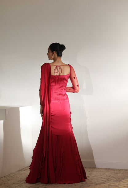 Woman wearing a red saree with a plain white background; Sunanta Madaan – Burgundy Raw Silk & Crepe Embroidered Corset Saree, Premium Designer Wear, Elegant Festive Outfit, Boho Indo-Western Dress, Indo-Western Fusion Wear, Indo-Western Attire for Engagement, Indo-Western Outfit for Sangeet, Indo-Western Draped & Embroidered Saree, Women’s Designer Saree, Mumbai, Delhi, Hyderabad, Bangalore, Pune, near me