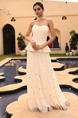 Elegant ivory sharara set for women featuring a beautifully embroidered peplum top paired with a flowing sharara. This designer sharara dress is perfect for brides, offering a luxurious bridal sharara look. The ensemble includes a stylish crop top with sharara, ideal for any special occasion. Explore this stunning sharara set online for a sophisticated, traditional look with modern appeal.