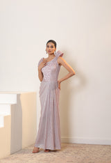 Woman wearing a light purple evening gown with a white background; Sunanta Madaan – Pink Metallic Lycra Crepe Embroidered Gown, Elegant Designer Wear, Evening Party Dress, Boho Indo-Western Dress, Indo-Western Fusion Wear, Women’s Formal Gown, Indo-Western Outfit for Reception, Party Outfit, Indo-Western Draped Dress, Mumbai, Jaipur, Bangalore, Ahmedabad, Pune, near me