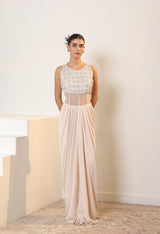 Woman wearing a long, elegant dress with a white top and sheer skirt against a neutral background. Sunanta Madaan – Ivory Crepe Satin Western Embroidered Gown, Premium Cocktail Wear, Elegant Party Outfit, Boho Indo-Western Dress, Indo-Western Fusion Wear, Women’s Formal Evening Dress, Indo-Western Outfit for Reception, Party Outfit, Indo-Western Draped Dress, Jaipur, Delhi, Hyderabad, Ahmedabad, Bangalore, near me